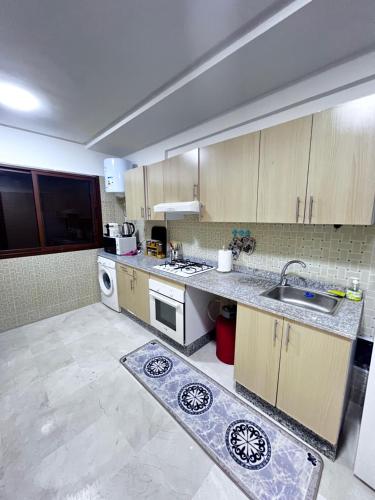 a kitchen with a sink and a stove top oven at Marrakech Gueliz Rue zellaqa in Marrakech