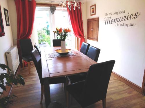 a dining room with a wooden table and chairs at Sweet Briar in Newquay