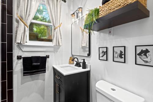 a small bathroom with a sink and a mirror at Modern Midtown-The Carriage House -Free Parking in Atlanta