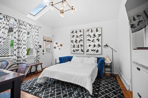 a bedroom with a bed and a table and chairs at Modern Midtown-The Carriage House -Free Parking in Atlanta