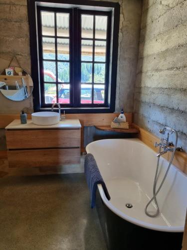 a large bathroom with a tub and a sink at Pikikirunga House, Takaka Hill in Upper Takaka