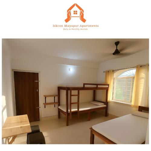 a small room with a desk and a table at ISKCON Mayapur Apartments - Daily & Monthly Rentals- PRIME LOCATION - SERVICED Apartment, 5 MIN to MAIN ISKCON TEMPLE in mayapur