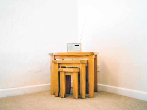 a small wooden table with a laptop on top of it at The Corn Store - Uk6716 in Lydstep