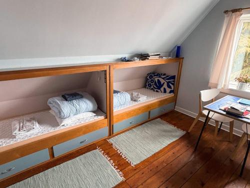 a room with two bunk beds and a table at 6 person holiday home in Hasle in Rønne