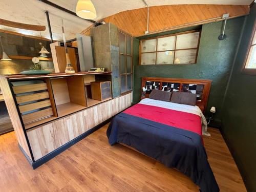 a bedroom with a bed in a small room at Loft acogedor en el campo in Putaendo