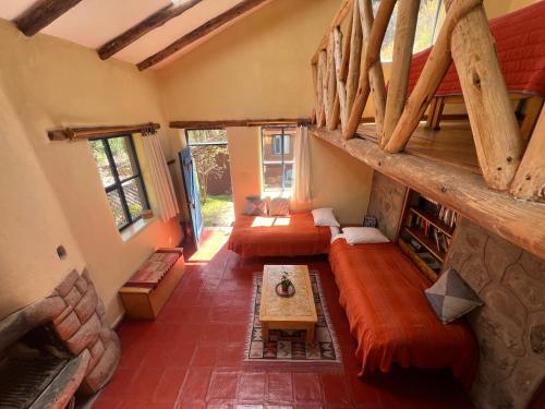 a living room with couches and a table in a house at Melissa Wasi in Pisac