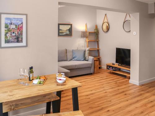 a living room with a couch and a table at South Snowdon Wharf in Porthmadog
