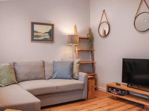 South Snowdon Wharf في بورثمادوج: غرفة معيشة مع أريكة وتلفزيون