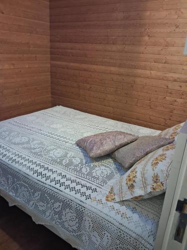 a bed with two pillows on top of it at Casa do Vale Encantado in Cedovim