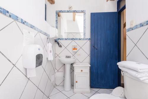 a white bathroom with a sink and a toilet at Melissa Wasi in Pisac
