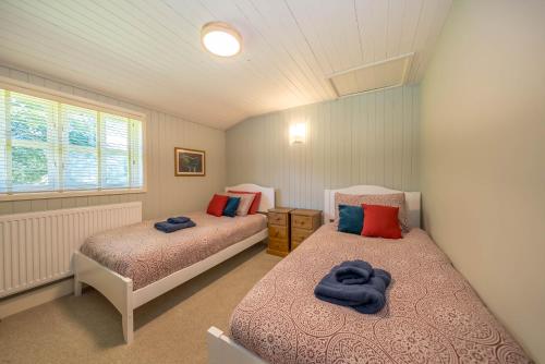 a bedroom with two beds and a window at Ffawydd-Y-Ffynnon in Llanfyrnach