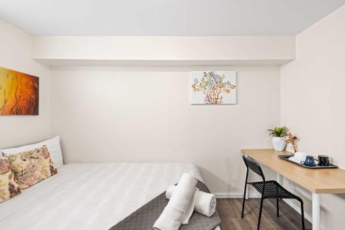 a small bedroom with a bed and a desk at Relaxed Private Double Room in Carramar - Close to Station - Shared Bathroom in Villawood