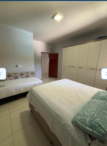 a large bedroom with two beds and a closet at casa sol e mar 01 in Paripueira