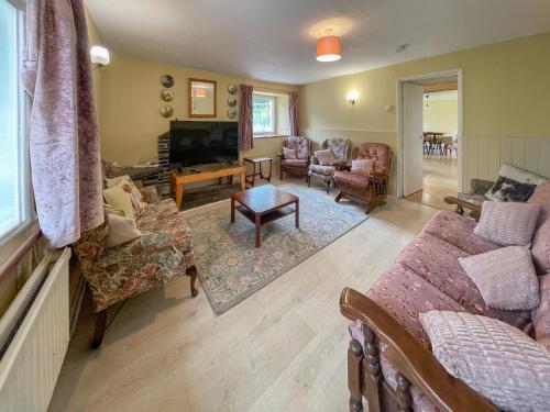 a living room with a couch and a tv at Hafod Fach - Ukc6956 in Moylgrove