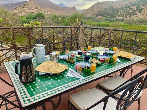 a table with food and drinks on a balcony at Hôtel Tawada in Azilal