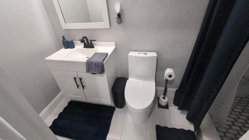 une salle de bain avec des toilettes blanches et un lavabo dans l'établissement Blue Dream Sunrise - Your journey, our passion, à Lakeland