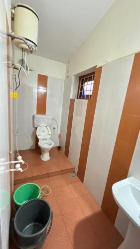 a bathroom with a toilet and a sink at Chillz Heaven Resorts - Ketti Palada in Coonoor