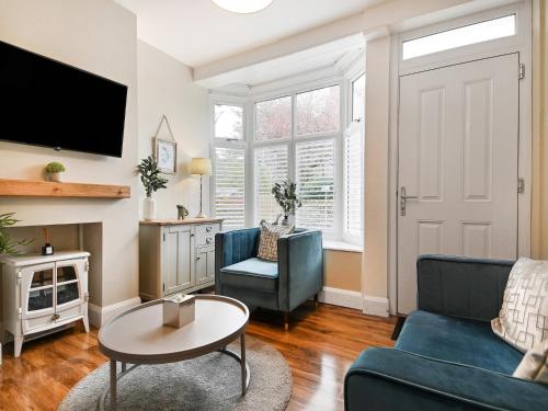 a living room with a couch and a table at Beaconsfield House in Mundesley