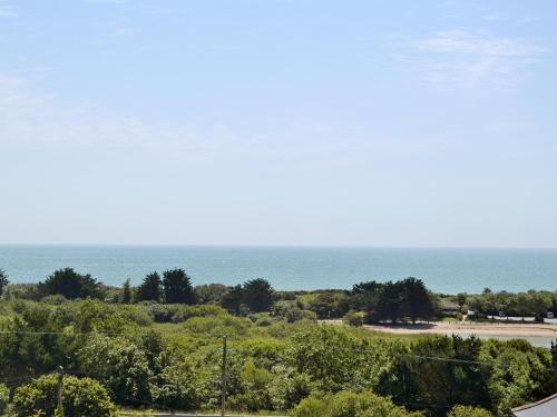 a view of the ocean from the balcony of a house at Sand Dunes in Tywardreath