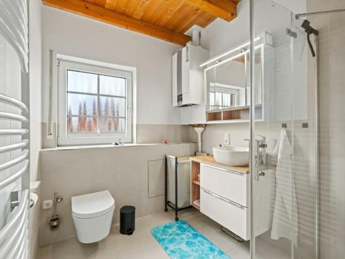 a bathroom with a sink and a toilet and a window at Holiday apartment with 2 bedrooms in Timmel