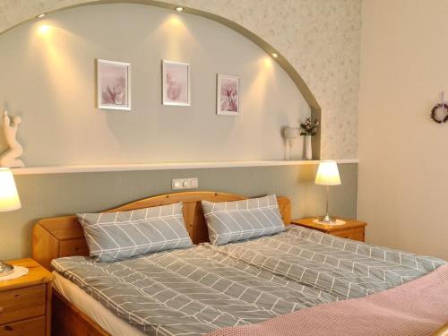a bedroom with a bed with an arch above it at Holiday apartment with 1 bedroom in Nindorf