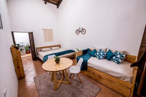 a bedroom with a bed and a table and a bed at Private Studio, Very Centric and Flexible Check-In in Antigua Guatemala