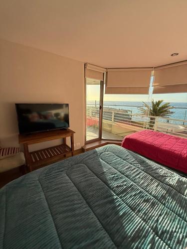 a bedroom with a bed and a view of the ocean at San Alfonso del Mar 7P in Algarrobo