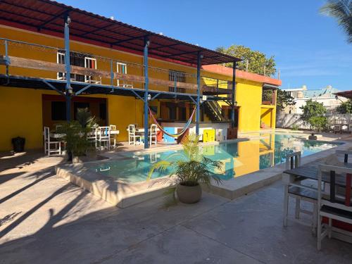 a swimming pool in a building with a playground at Hotel Chuburna in Chuburná
