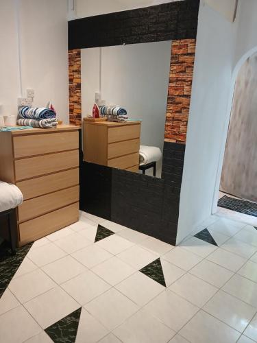 a salon with a mirror in a room at Studio - Chantilla Vie in Trou aux Biches