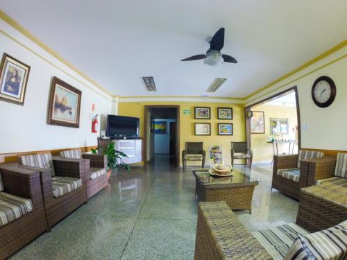a living room with couches and a ceiling fan at Hotel Graunas in São Carlos