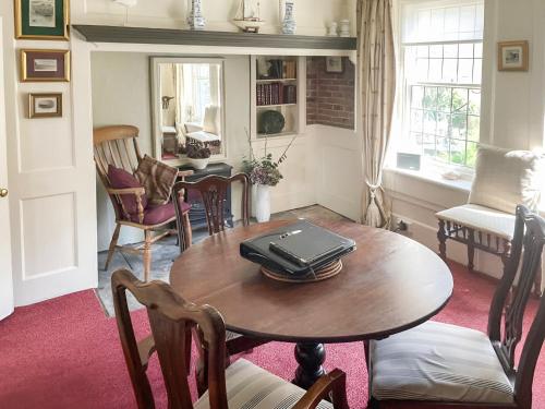 a room with a table with a laptop on it at Seacrest Cottage in Whitby