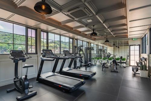 a gym with treadmills and elliptical machines at Chateau Du Village Patong in Patong Beach