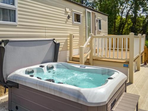 una bañera de hidromasaje en una terraza con una casa en Hillcrest Caravan - Uk44798, en Hemswell
