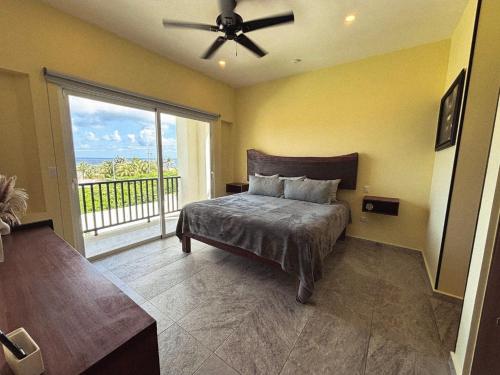 een slaapkamer met een bed en een groot raam bij Holiday apartment at La Diosa condos Isla Mujeres in Isla Mujeres
