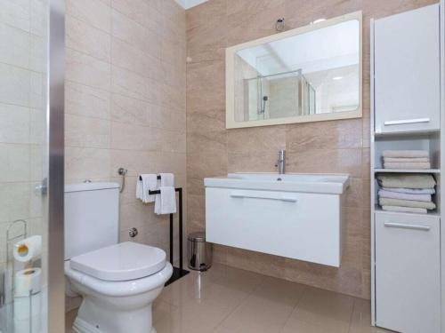 een badkamer met een toilet, een wastafel en een spiegel bij Holiday home in Slivno with swimming pool in Slivno