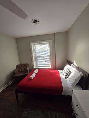 a bedroom with a large bed with a red blanket at Grand House in Chicago