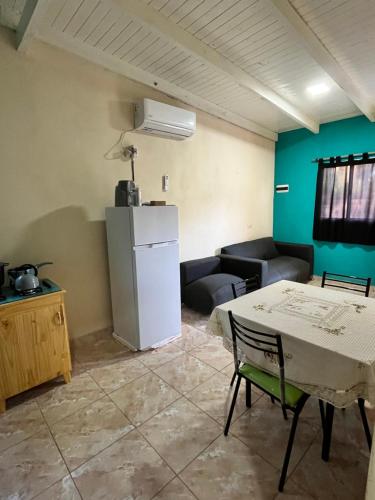 a living room with a table and a refrigerator at Alojamiento MD in Wanda