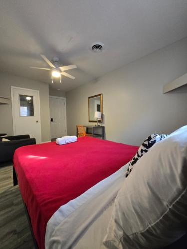 a bedroom with a large bed with a red blanket at Grand House in Chicago
