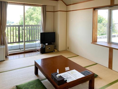 a living room with a table and a tv at 芸西村の家 in Geisei