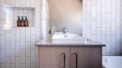 a bathroom with a sink and a tub at The Robinson in Connewarre