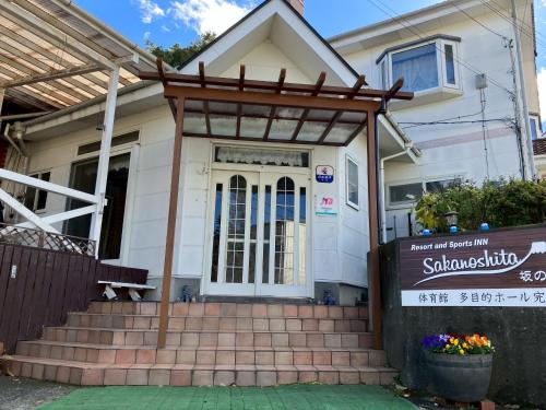 a house with a gate and stairs in front of it at Resort inn Sakanoshita in Fujikawaguchiko