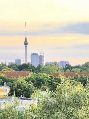 a view of a city with a tv tower in the background at Big 24qm Room Cozy Trendy Multicultural LGTB Friendly in Shared Apartment in Green Area 12 min to Downtown Alexanderplatz in Berlin