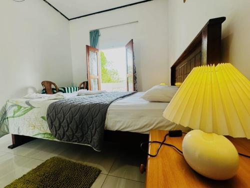 a bedroom with a bed and a lamp on a table at Viyan hotel in Negombo