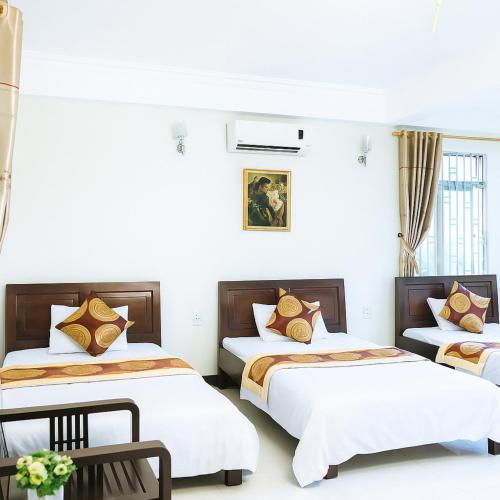 three beds in a room with white walls at Thanh Hà Hotel Lào Cai in Lao Cai