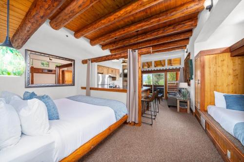 a bedroom with two beds and a dining room at Chipeta Lodge in Ridgway
