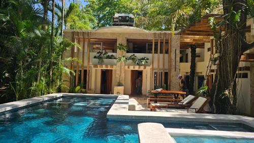 a swimming pool in front of a house at Toro by Dreamcatcher in Santa Teresa Beach