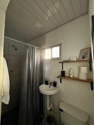 a bathroom with a sink and a toilet and a shower at Casa Onca in Río Claro