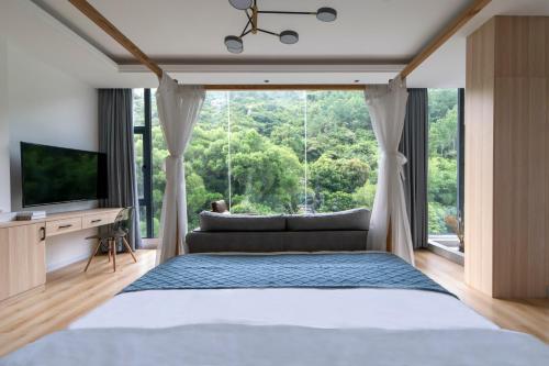 Ένα ή περισσότερα κρεβάτια σε δωμάτιο στο Sheng Hai Yun Ju