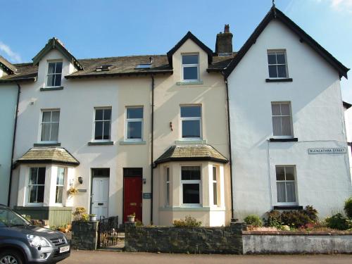 a white house with a car parked in front of it at York House in Keswick