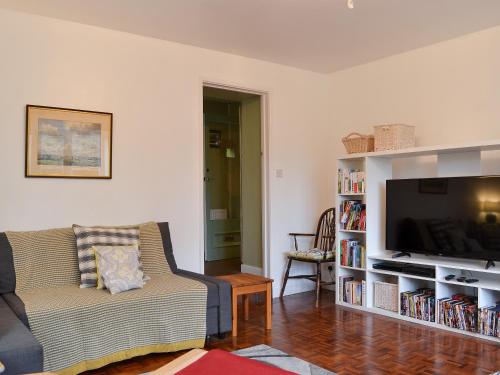 a living room with a couch and a flat screen tv at Burrills View in Horderley